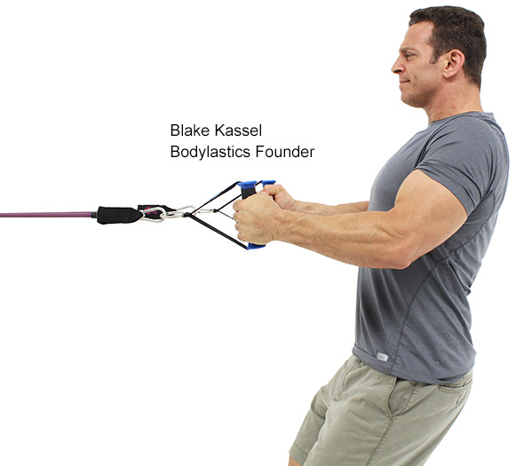 Bodylastics founder Blake Kassel rows a Bodylastics band handle toward his chest with a band anchored in front of him.