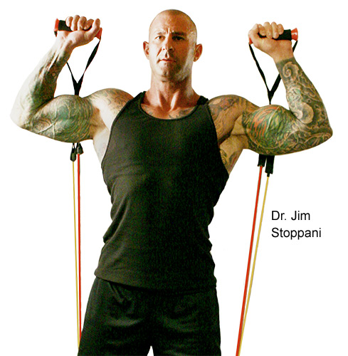 Dr. Jim Stoppani holds two Bodylastics band handles at his shoulders, ready to press them overhead.